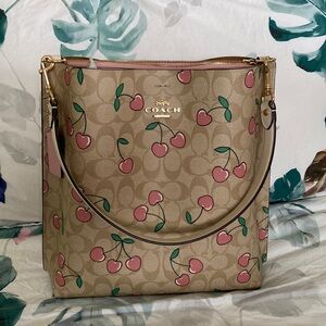 Coach cherry print shoulder bag with crossbody strap